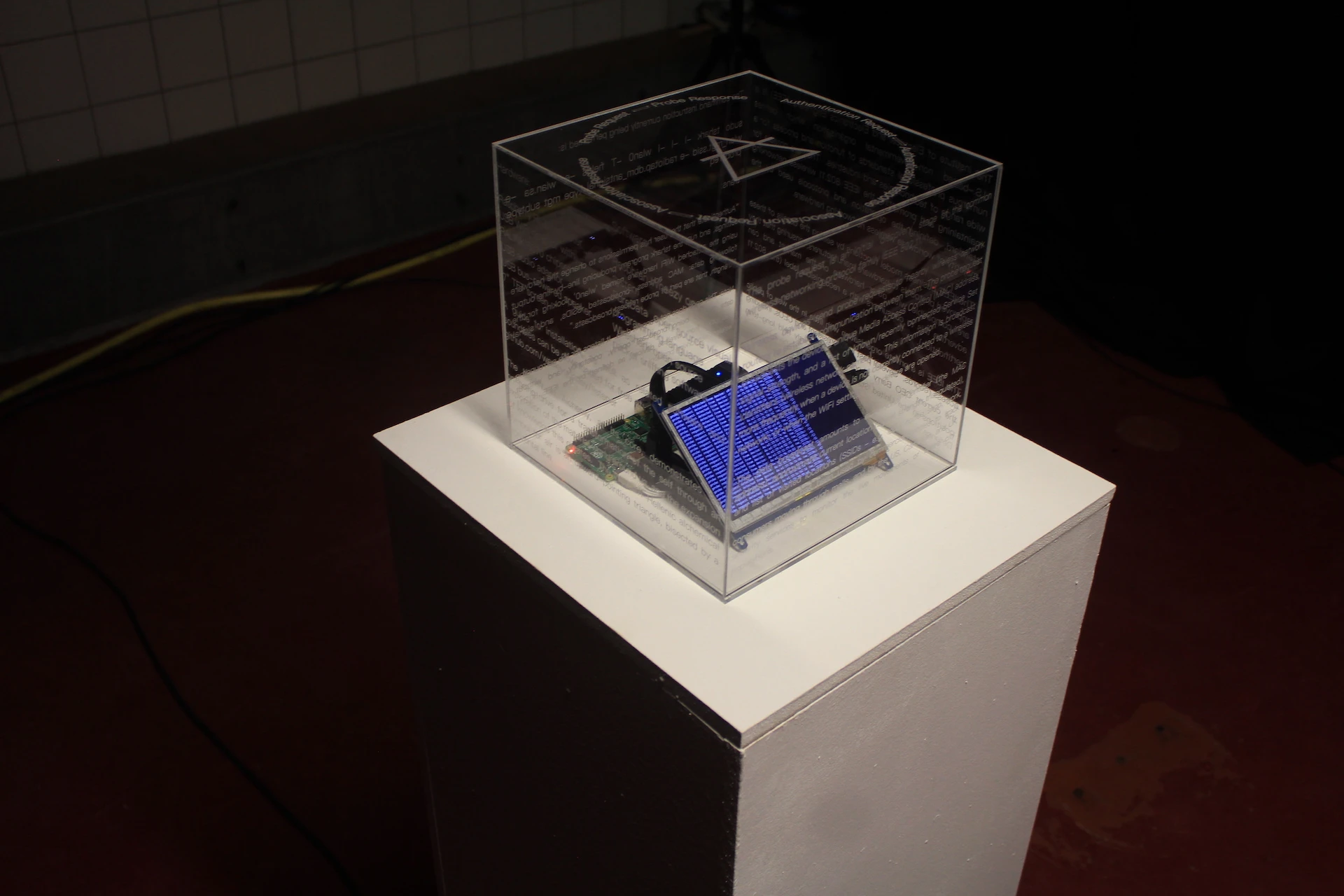 Detail view of the installation, a perspex box with Raspberry Pi and screen inside.