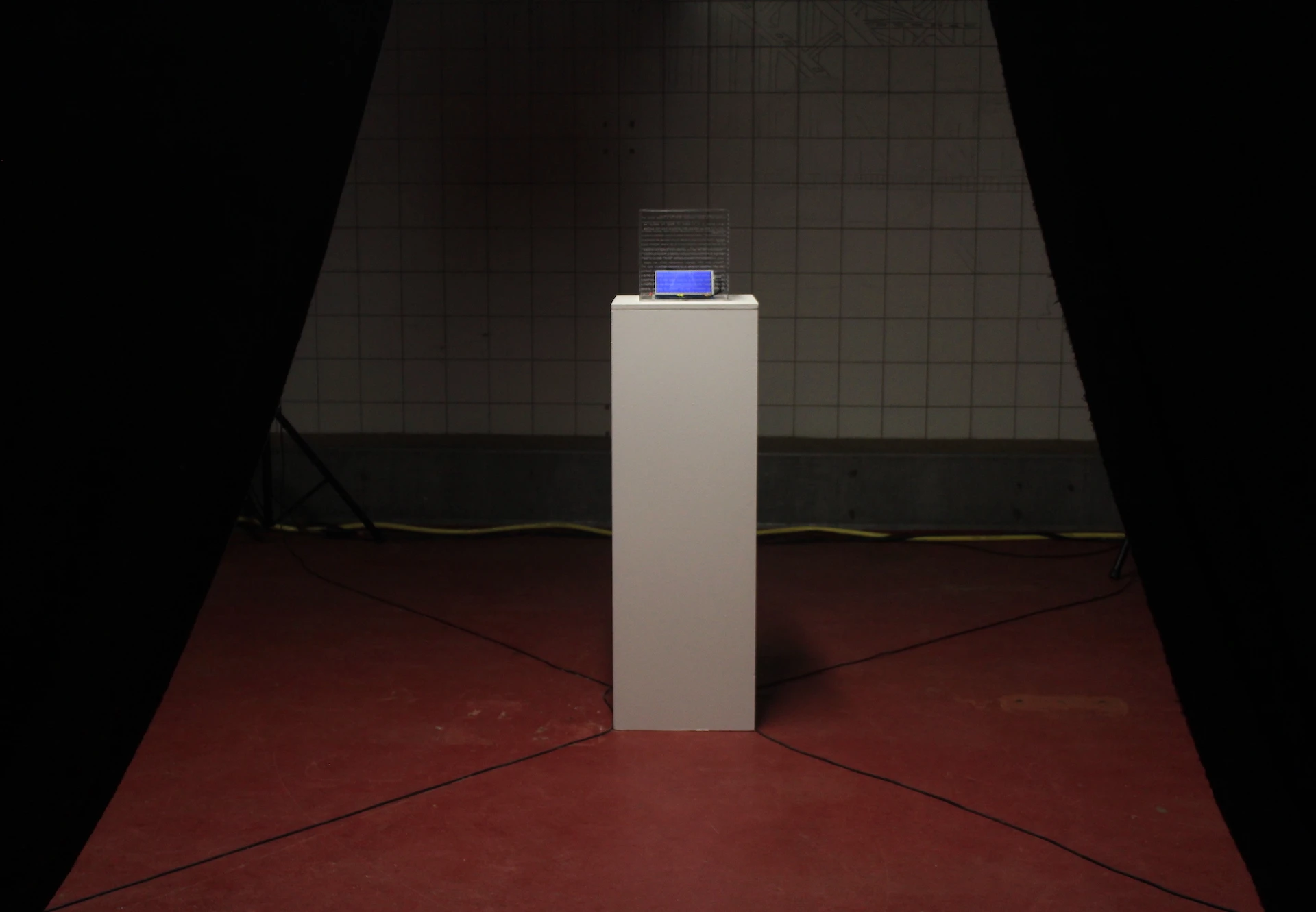 A transparent acrylic cube with electronic components inside, glowing.
